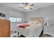 Comfortable bedroom with a ceiling fan and large windows providing ample natural light and views at 10035 Oak Creek Canyon Ave, Las Vegas, NV 89147