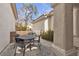 Inviting outdoor seating area with a wrought-iron table and chairs in a private courtyard at 10035 Oak Creek Canyon Ave, Las Vegas, NV 89147