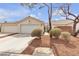 Charming single-story home featuring a well-manicured front yard and an attached two-car garage at 10035 Oak Creek Canyon Ave, Las Vegas, NV 89147