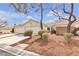 Charming single-story home featuring a well-manicured front yard and an attached two-car garage at 10035 Oak Creek Canyon Ave, Las Vegas, NV 89147