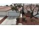 Charming home featuring a well maintained front yard with mature trees and a two-car garage at 10035 Oak Creek Canyon Ave, Las Vegas, NV 89147