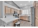 Bright kitchen featuring stainless steel appliances, wood cabinets, and a tiled countertop at 10035 Oak Creek Canyon Ave, Las Vegas, NV 89147