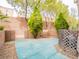Private backyard patio with mature landscaping and blue concrete, perfect for outdoor relaxation at 10051 Sand Key St, Las Vegas, NV 89178