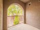Balcony with metal railing and an arched doorway entrance at 10051 Sand Key St, Las Vegas, NV 89178