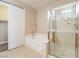 Bright bathroom with a separate tub and shower enclosed in clear glass at 10051 Sand Key St, Las Vegas, NV 89178