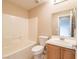 Bright bathroom featuring a tub-shower combination and a vanity with wood cabinets at 10051 Sand Key St, Las Vegas, NV 89178