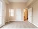 This bedroom features neutral walls and carpet, base molding, with a glass paned door and window at 10051 Sand Key St, Las Vegas, NV 89178