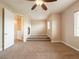 Cozy carpeted bedroom with an adjacent fireplace and multi-step platform feature at 10051 Sand Key St, Las Vegas, NV 89178