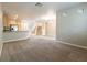 Open-concept kitchen and living area with granite counters, stainless steel appliances, and a staircase at 10051 Sand Key St, Las Vegas, NV 89178