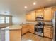 This kitchen features light wood cabinets, stainless steel appliances, and granite countertops at 10051 Sand Key St, Las Vegas, NV 89178