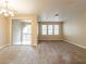 Spacious carpeted living room with bright natural light and a sliding glass door to a patio at 10051 Sand Key St, Las Vegas, NV 89178