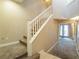 A view of the staircase with carpeted steps and a white railing leading to the upper floor at 10051 Sand Key St, Las Vegas, NV 89178