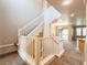 A view of the home's staircase, which has white wood banisters and carpeted steps at 10051 Sand Key St, Las Vegas, NV 89178