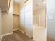 Large walk-in closet with beige colored walls leading to bathroom at 10051 Sand Key St, Las Vegas, NV 89178