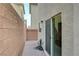 Exterior view of a cozy backyard featuring brick pavers and a building exterior at 10722 Red Badge Ave, Las Vegas, NV 89166