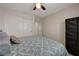 A calm bedroom features a sliding closet, cozy bed, and a ceiling fan at 10722 Red Badge Ave, Las Vegas, NV 89166