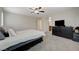 Light and bright bedroom features gray carpet, a ceiling fan and windows with plantation shutters at 10722 Red Badge Ave, Las Vegas, NV 89166