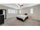 Spacious bedroom features plush gray carpet, neutral walls, ceiling fan and windows with plantation shutters at 10722 Red Badge Ave, Las Vegas, NV 89166