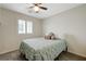 Cozy bedroom featuring a queen-sized bed, ceiling fan, and a bright window at 10722 Red Badge Ave, Las Vegas, NV 89166
