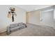 Bright bonus room offers flexible space with gray carpet flooring and a decorative shelf with books at 10722 Red Badge Ave, Las Vegas, NV 89166
