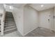 Bright entryway featuring wood-look tile floors, neutral walls, and a staircase leading to the upper level at 10722 Red Badge Ave, Las Vegas, NV 89166