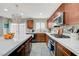 Beautiful kitchen with an island, stainless steel appliances, and brown cabinetry at 10722 Red Badge Ave, Las Vegas, NV 89166