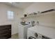 Practical laundry room equipped with washer, dryer, and functional storage shelves at 10722 Red Badge Ave, Las Vegas, NV 89166
