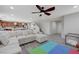 Spacious living area with a sofa, open layout, and seamless flow into other living spaces at 10722 Red Badge Ave, Las Vegas, NV 89166