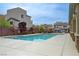 Community pool with light blue water is surrounded by a concrete deck and nearby housing at 10722 Red Badge Ave, Las Vegas, NV 89166