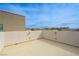 Rooftop deck with stucco walls overlooking the neighborhood and mountains on a sunny day at 10722 Red Badge Ave, Las Vegas, NV 89166