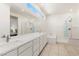 Bright bathroom with dual sinks, large mirror, tub, and separate shower featuring modern fixtures at 10879 Artesano Ave, Las Vegas, NV 89135