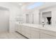 Bright bathroom with double sinks, sleek cabinetry, and a large mirror at 10879 Artesano Ave, Las Vegas, NV 89135