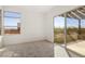 Sunlit bedroom with access to a balcony offering views of the desert landscape at 10879 Artesano Ave, Las Vegas, NV 89135