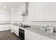 Contemporary kitchen features stainless steel appliances, sleek white cabinets, and granite countertops at 10879 Artesano Ave, Las Vegas, NV 89135