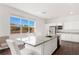 Bright kitchen features a large island with granite countertops, stainless steel appliances, and white cabinetry at 10879 Artesano Ave, Las Vegas, NV 89135