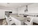 Spacious kitchen showcasing an island with granite countertop, stainless appliances, and white cabinets at 10879 Artesano Ave, Las Vegas, NV 89135