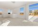 Bright living room with large windows offering scenic views of the surrounding neighborhood at 10879 Artesano Ave, Las Vegas, NV 89135
