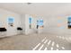 Spacious living area with large windows, high ceilings, and modern bar stool seating at 10879 Artesano Ave, Las Vegas, NV 89135