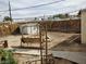 Large backyard space with mature plants, a garden swing, and a storage shed at 110 Palm Ln, Las Vegas, NV 89101