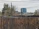 Backyard view with wood fence and cityscape in background at 110 Palm Ln, Las Vegas, NV 89101