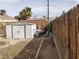 Exterior view of the backyard featuring a utility shed and wood fence at 110 Palm Ln, Las Vegas, NV 89101