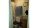 Cozy bathroom with tiled shower, neutral-colored walls, a framed art print, and vanity storage at 110 Palm Ln, Las Vegas, NV 89101