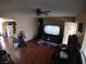 Cozy living room featuring ceiling fan, wood flooring, and television at 110 Palm Ln, Las Vegas, NV 89101