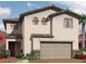 Inviting two-story home featuring desert landscaping, a neutral color palette, and an attached two-car garage at 1108 Boylston Ave, North Las Vegas, NV 89030