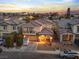 Gorgeous aerial shot of a two-story home with city views at sunset at 1309 Rainy Sky Ave, North Las Vegas, NV 89030