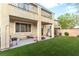 Spacious backyard boasts artificial turf and covered patio space at 1309 Rainy Sky Ave, North Las Vegas, NV 89030