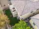 Aerial view of a well-maintained backyard with artificial turf, balcony, and lawn care equipment at 1309 Rainy Sky Ave, North Las Vegas, NV 89030