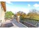 Balcony with outdoor seating, overlooking lush landscaping and trees at 1309 Rainy Sky Ave, North Las Vegas, NV 89030