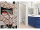 This bathroom includes a mosaic storage cabinet and a blue vanity with sink at 1309 Rainy Sky Ave, North Las Vegas, NV 89030