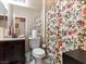 Cozy bathroom featuring a floral shower curtain, and a granite vanity at 1309 Rainy Sky Ave, North Las Vegas, NV 89030